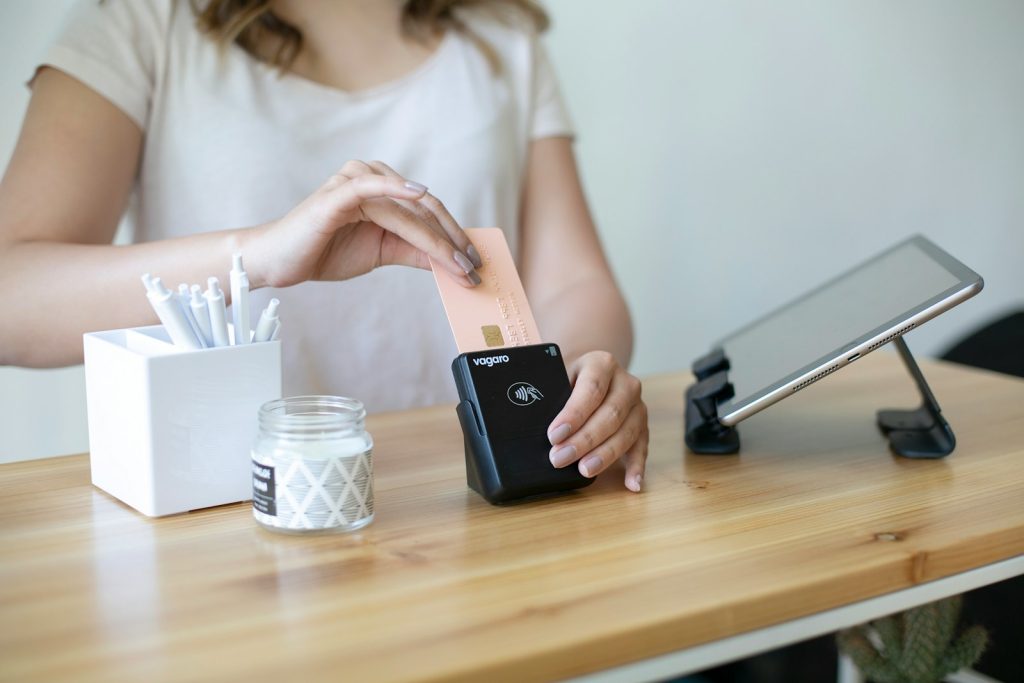 a woman is holding a piece of paper and putting it in a container