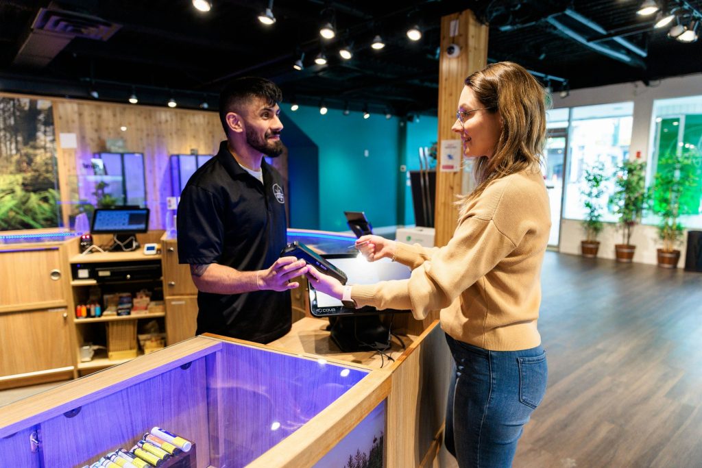 a man and a woman standing in front of a fish tank